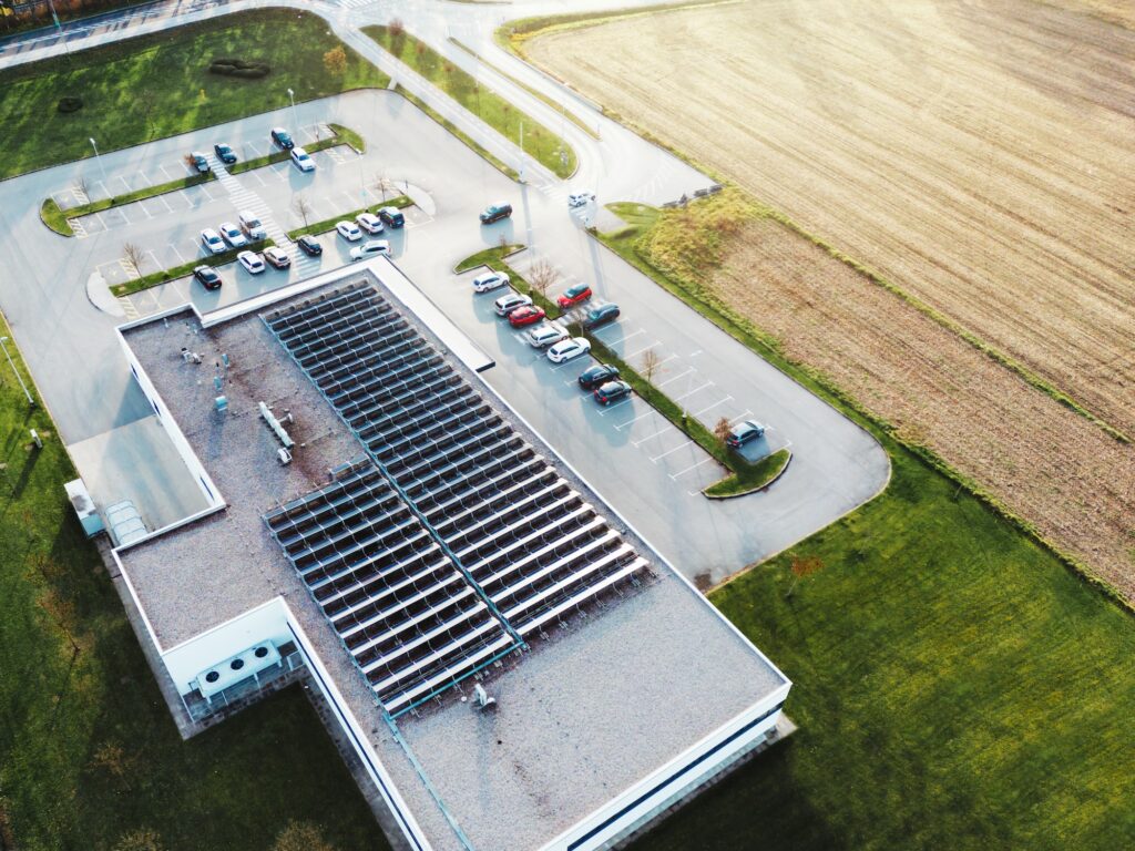 Aerial view of an industrial building with solar panels on the roof